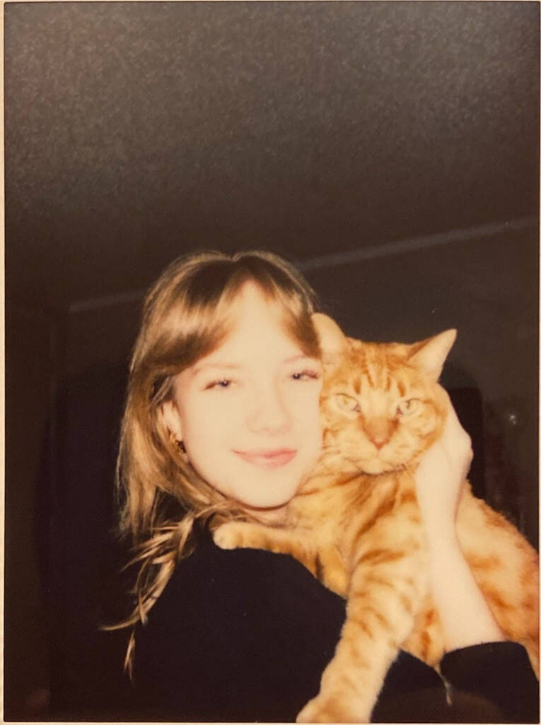 Jessica Frielink smiling and holding her orange cat